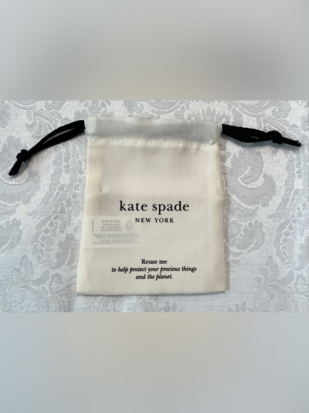 Kate Spade Drawstring Jewelry Pouch in Cream with Black Ties